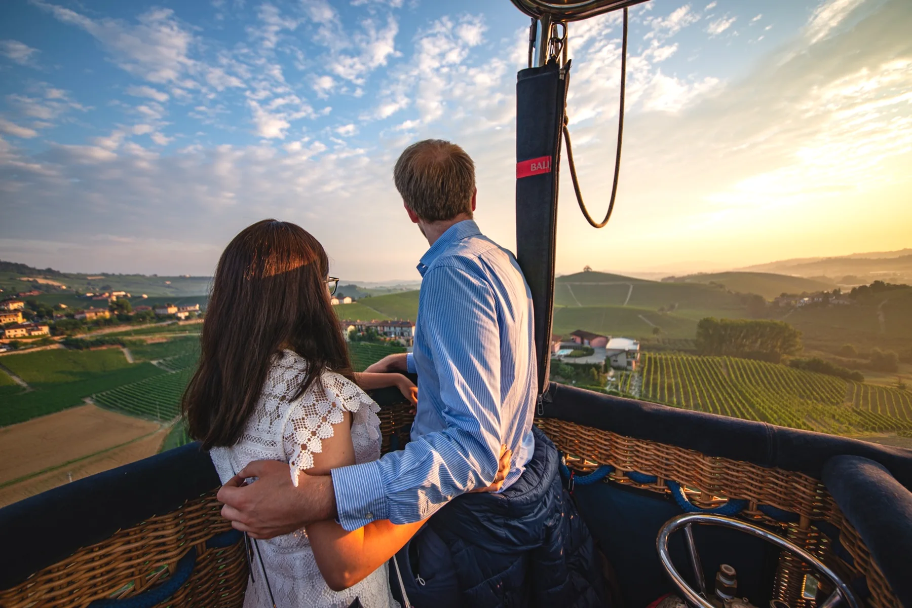 A couple looking across the hills from a balloon basket
